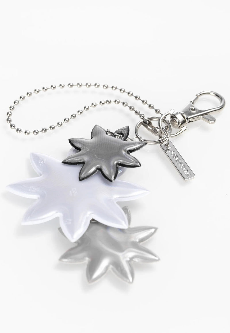 Lasessor Edelweiss heijastin - musta hopea - kukka - koruheijastin - laukkukoru -  asusteet - IHANA Store