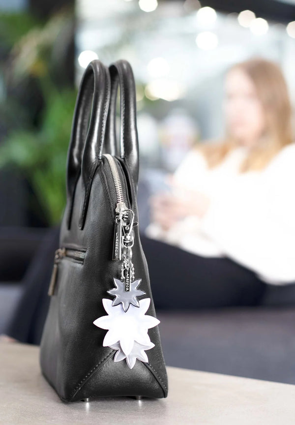 Lasessor Edelweiss heijastin - musta hopea - kukka - koruheijastin - laukkukoru -  asusteet - IHANA Store